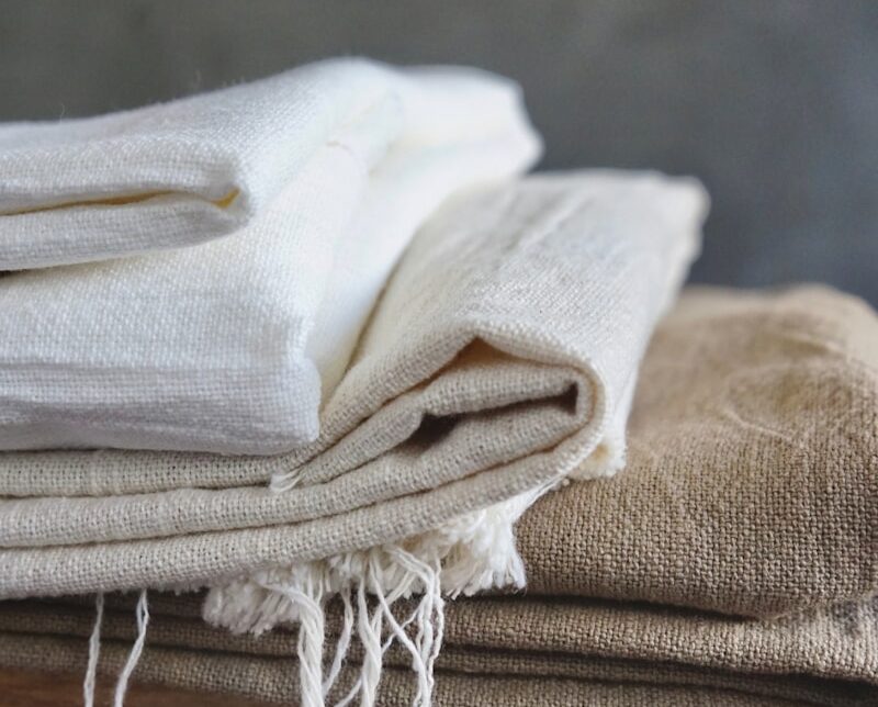 white textile on brown wooden table