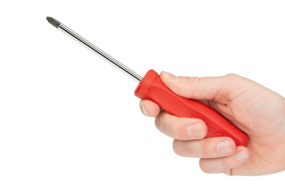 person holding red and silver screw driver
