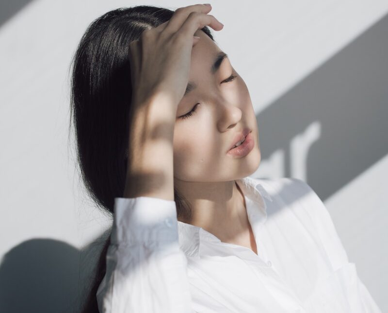 woman leaning on white table
