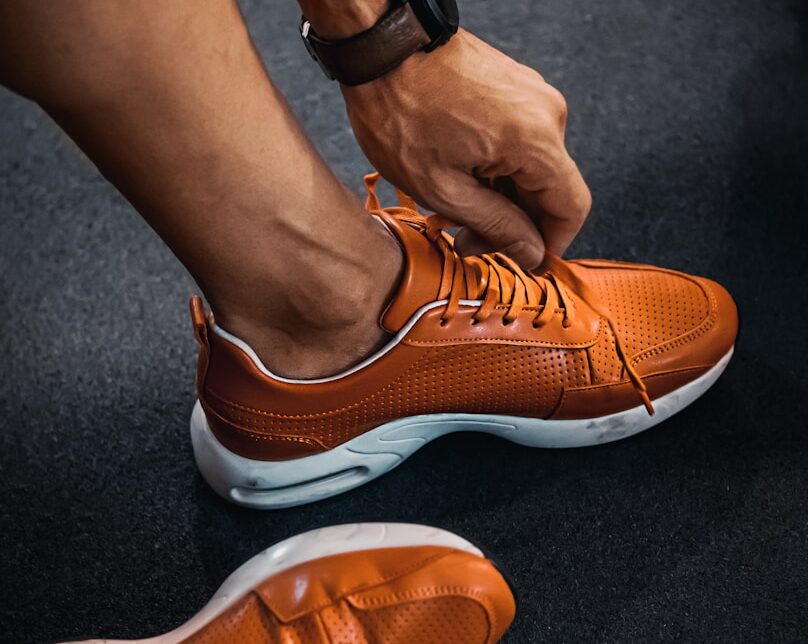 person wearing orange nike sneakers