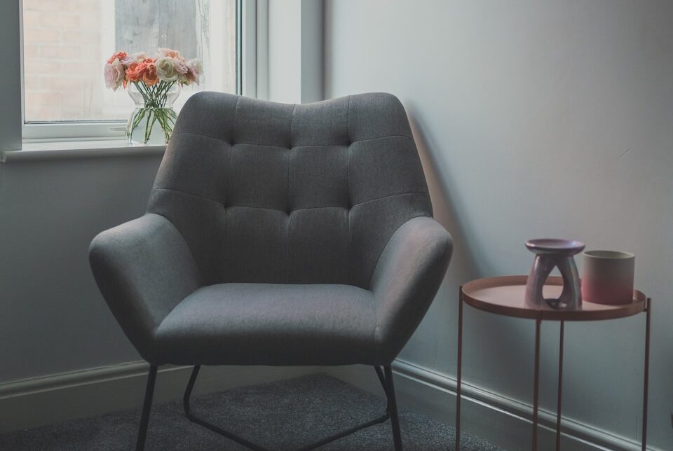 gray sofa chair beside glass window