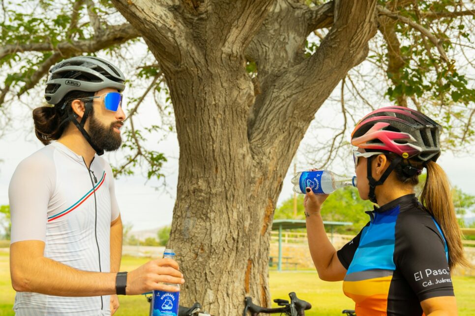 a man and a woman standing next to a tree