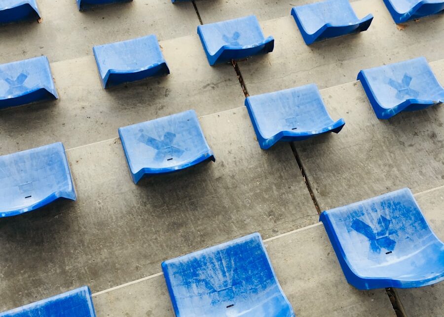 a bunch of blue seats sitting on a sidewalk