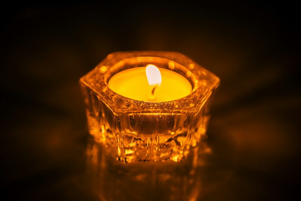 A lit candle sitting on top of a table