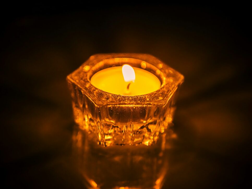 A lit candle sitting on top of a table