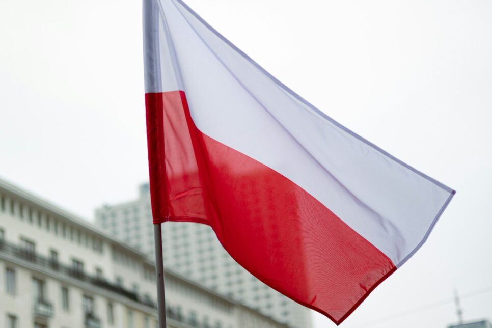 The polish flag waves in the breeze.