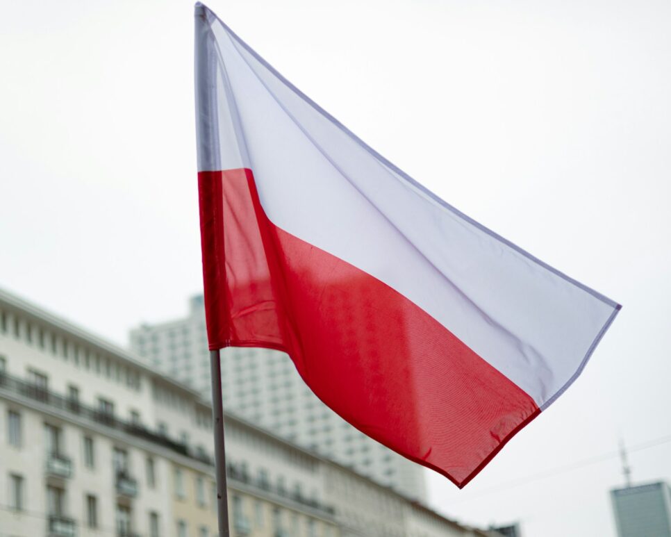 The polish flag waves in the breeze.